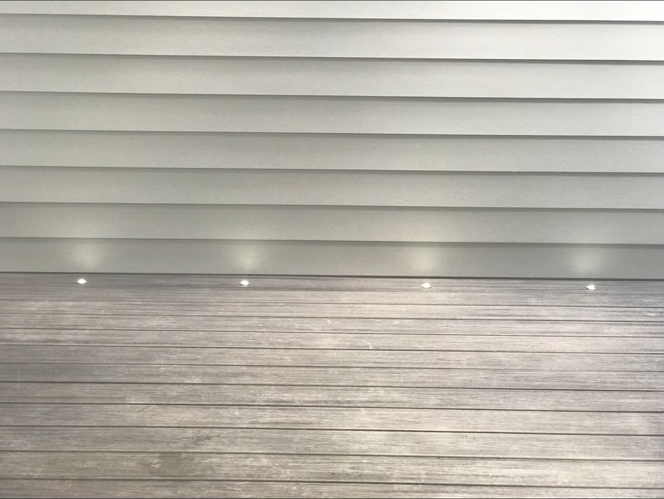 Recessed deck lights set into cladding and decking boards