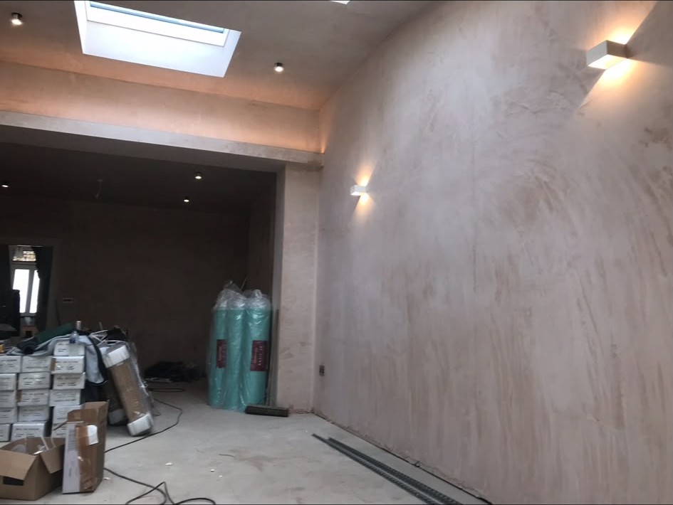 Wall lights installed and wired in a room during a renovation