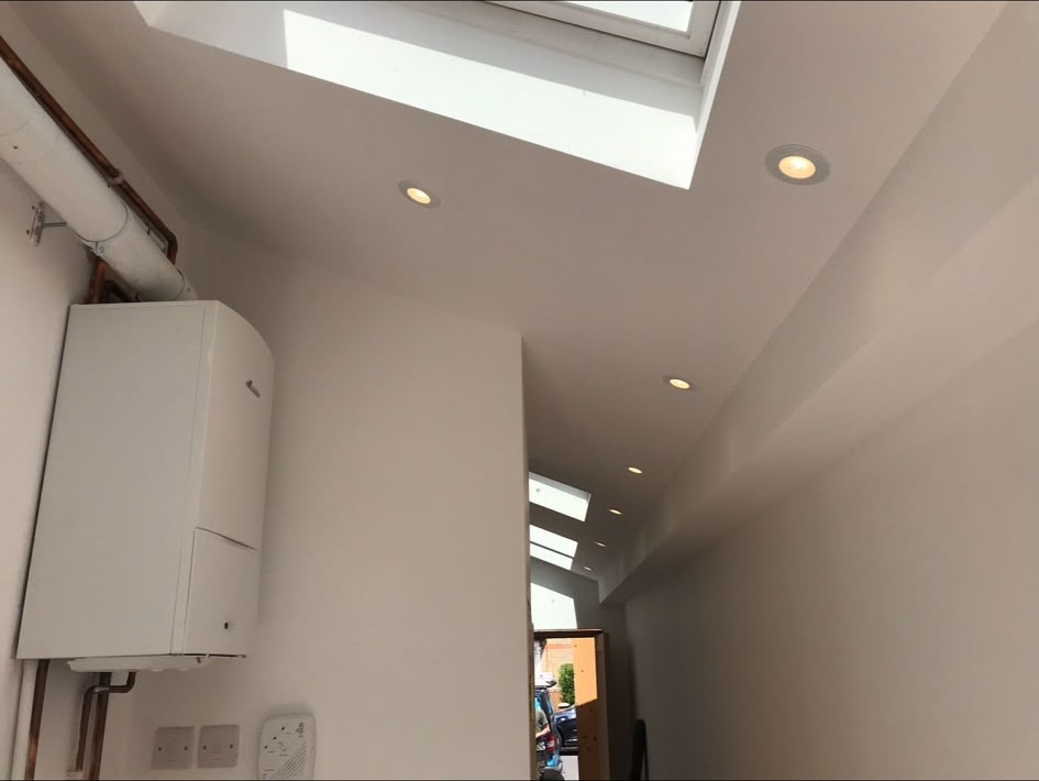 Hallway ceiling downlights installed alongside skylights