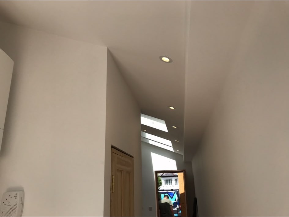 Downlights installed along a hallway ceiling after a refurbishment