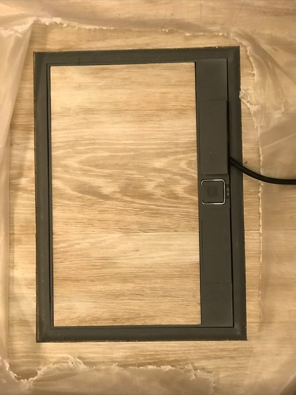 Recessed floor socket box installed flush into a living room floor