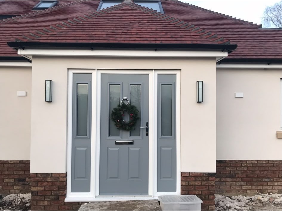 Exterior wall lights fitted either side of a front entrance door